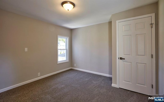 empty room with dark carpet