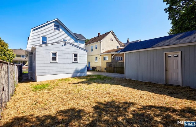 rear view of property with a yard