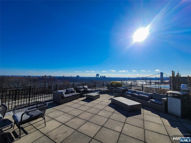 view of patio / terrace featuring a water view, grilling area, and an outdoor hangout area