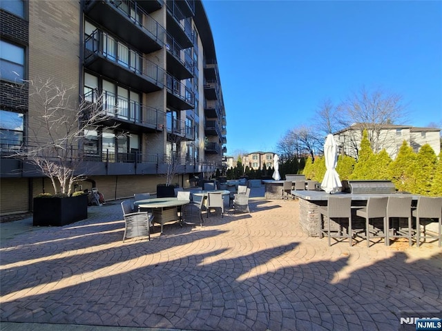 view of property's community featuring an outdoor bar and a patio area