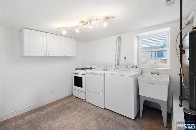 laundry area featuring cabinets, sink, and washer and dryer