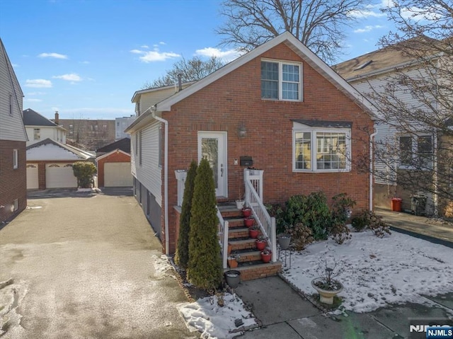 view of front of house featuring a garage and an outdoor structure