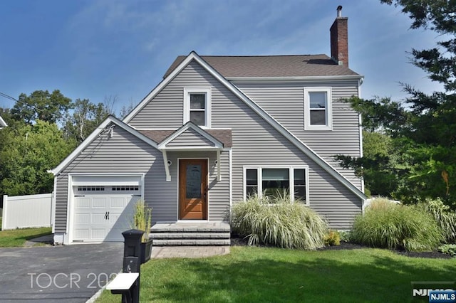 view of front of home featuring a garage and a front lawn