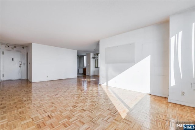 unfurnished room with light parquet flooring