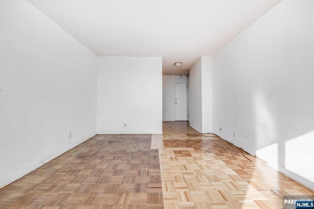 unfurnished room with light parquet flooring