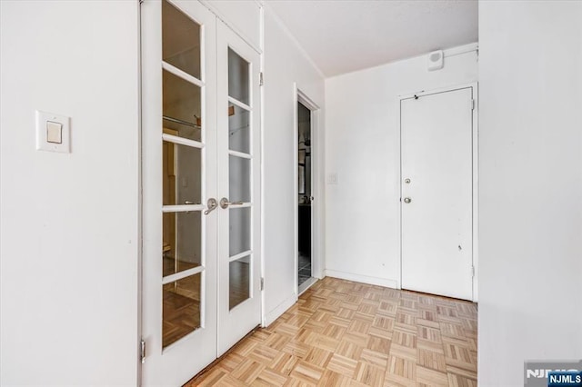 hallway with light parquet flooring and french doors