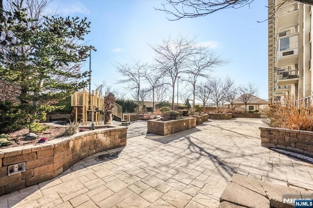 view of community featuring a patio and a playground