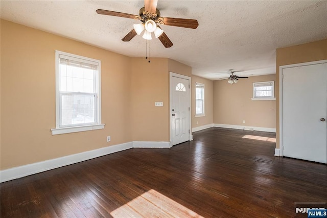 foyer with ceiling fan, dark hardwood / wood-style floors, and a textured ceiling