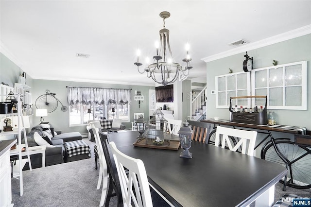 dining room with crown molding, a chandelier, and carpet