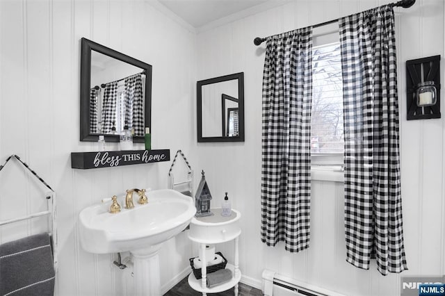 bathroom with ornamental molding and a baseboard radiator