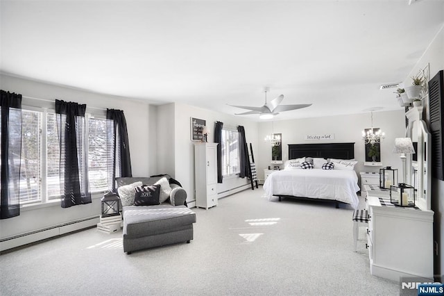 carpeted bedroom featuring a baseboard heating unit and ceiling fan with notable chandelier