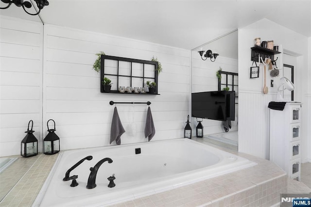 bathroom featuring a relaxing tiled tub