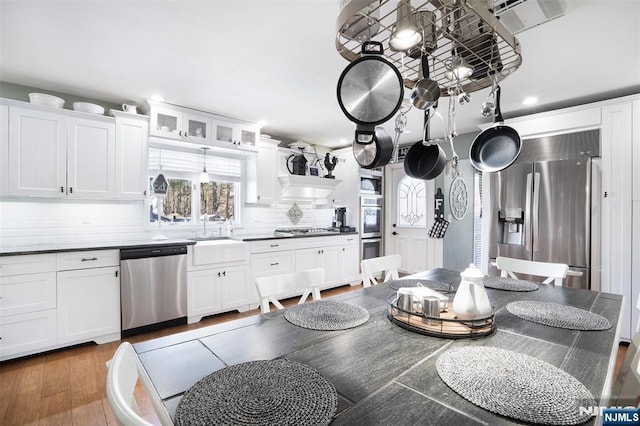 kitchen featuring a healthy amount of sunlight, sink, white cabinets, and appliances with stainless steel finishes