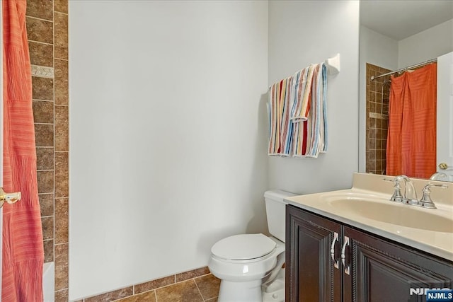 bathroom with vanity, tile patterned floors, and toilet