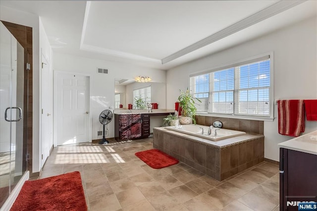 bathroom featuring vanity, plus walk in shower, and a raised ceiling