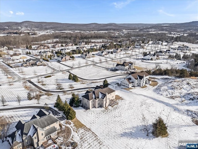 snowy aerial view with a mountain view