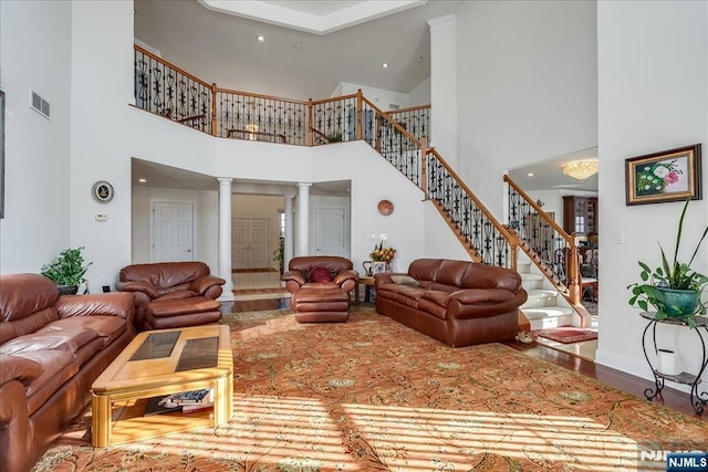 living room featuring hardwood / wood-style flooring and ornate columns