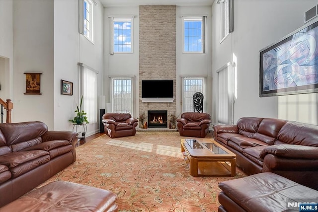 living room featuring a fireplace and plenty of natural light