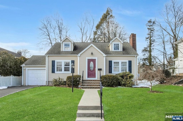 cape cod home featuring a garage and a front yard