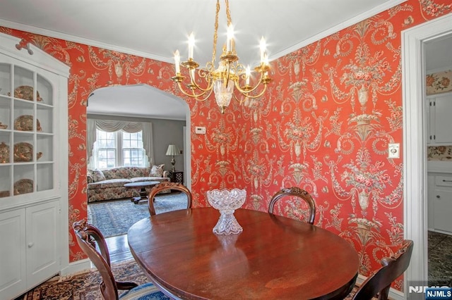 dining room featuring crown molding and a notable chandelier