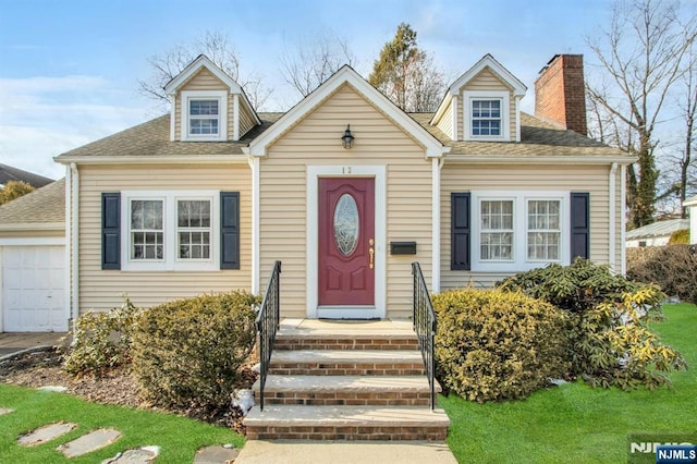 cape cod house featuring a garage