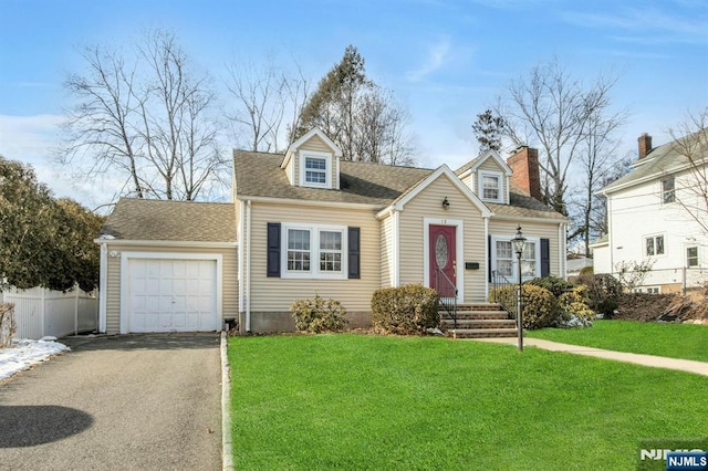 cape cod house featuring a garage and a front yard