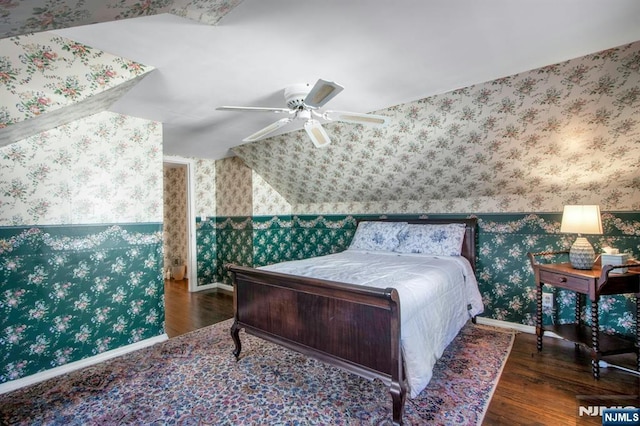 bedroom featuring dark wood-type flooring, ceiling fan, and lofted ceiling