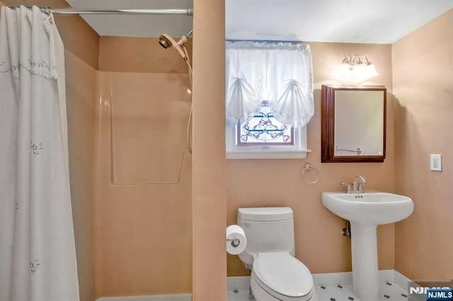 bathroom with a shower with curtain and toilet