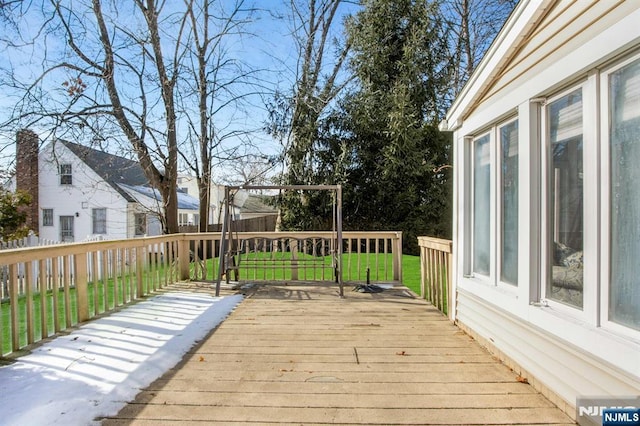 wooden terrace featuring a lawn