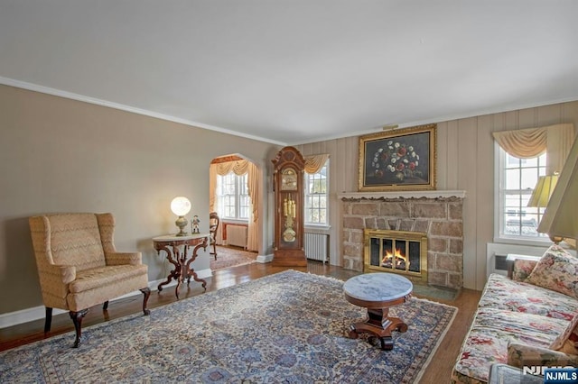 living room with radiator, crown molding, and hardwood / wood-style floors