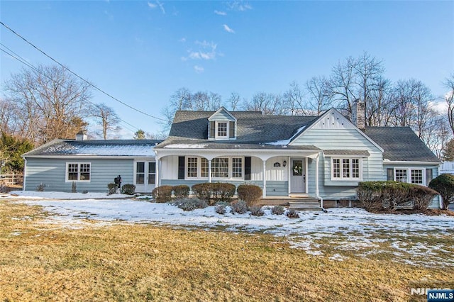 view of front of house with covered porch and a lawn