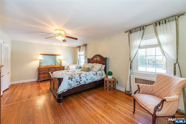 bedroom with ceiling fan and light hardwood / wood-style flooring