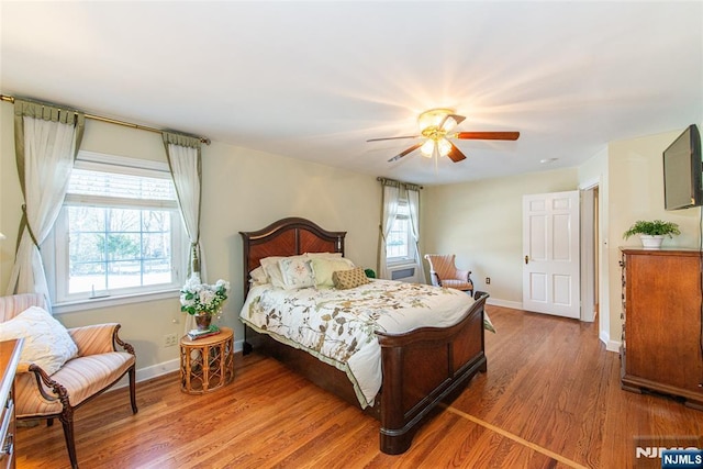 bedroom with ceiling fan and hardwood / wood-style floors