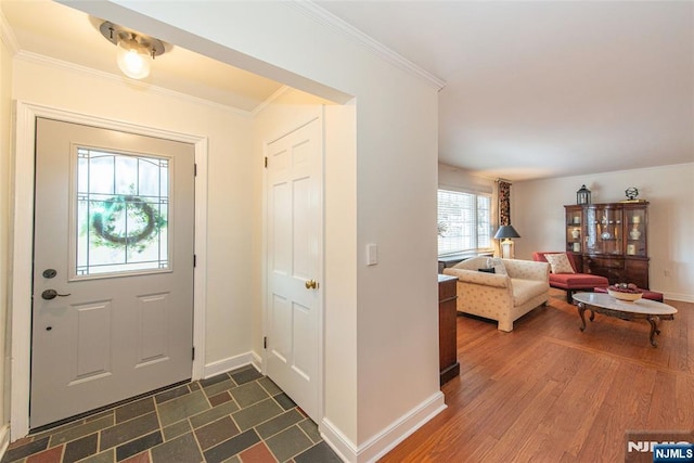 entrance foyer with dark wood-type flooring and ornamental molding