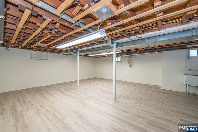 basement featuring hardwood / wood-style flooring