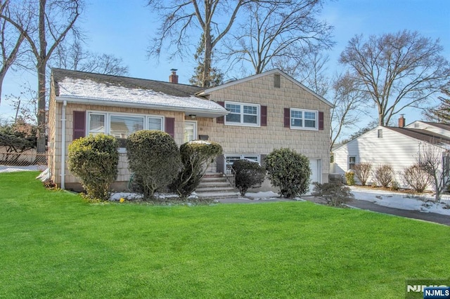 split level home featuring a front lawn