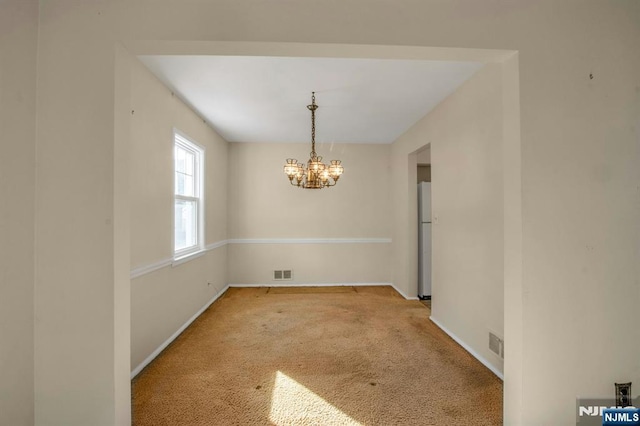 unfurnished dining area with light carpet and a notable chandelier