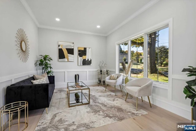 living room featuring hardwood / wood-style floors and crown molding