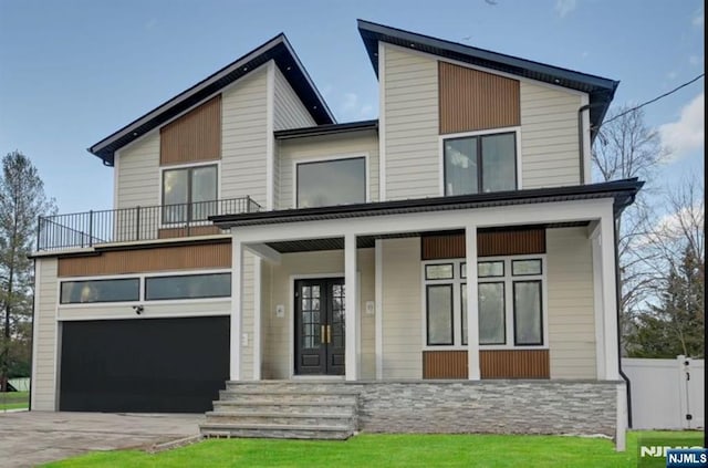 view of front facade with a porch and a garage