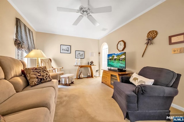 carpeted living room featuring ceiling fan and ornamental molding