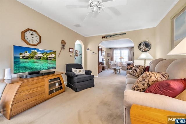 carpeted living room featuring crown molding and ceiling fan