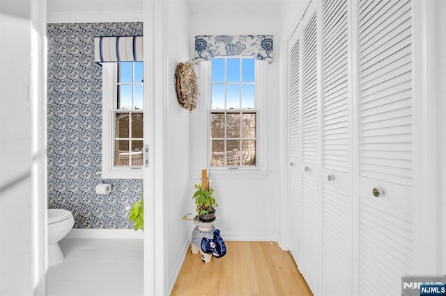 bathroom with hardwood / wood-style floors and toilet