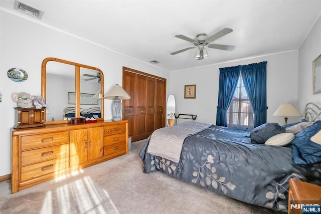 bedroom with light carpet and ceiling fan