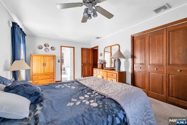 bedroom with ceiling fan, carpet floors, and a closet