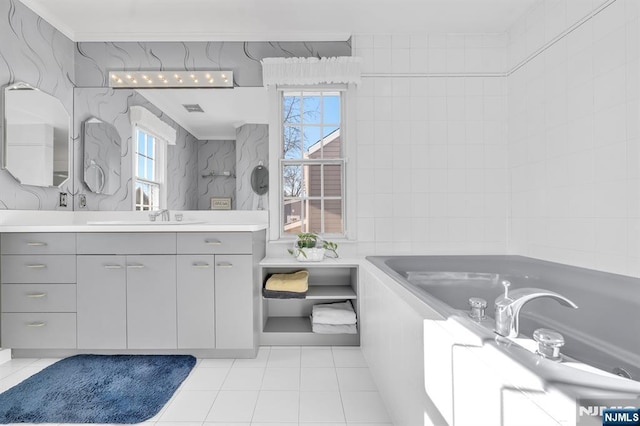 bathroom featuring tile walls, vanity, a relaxing tiled tub, crown molding, and tile patterned floors