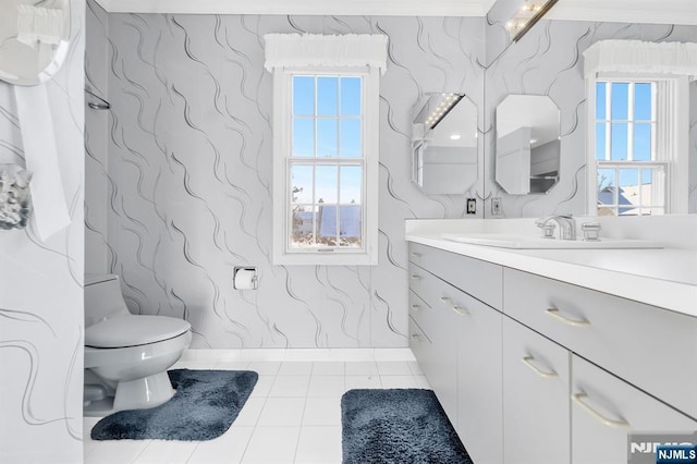 bathroom with vanity, toilet, and tile patterned flooring