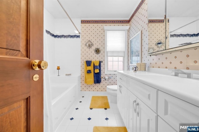 bathroom featuring tile patterned floors, toilet, a bathtub, and vanity