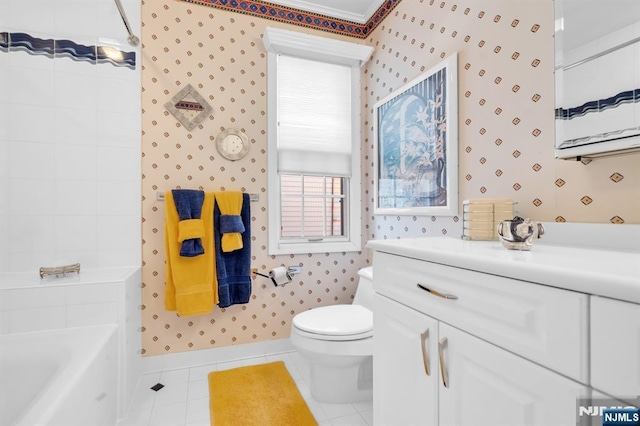 bathroom with vanity, toilet, tile patterned flooring, and a tub