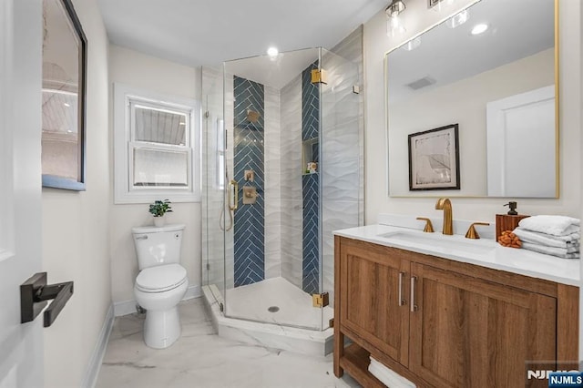 bathroom featuring vanity, toilet, and a shower with door