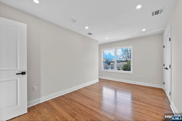 spare room with light hardwood / wood-style flooring